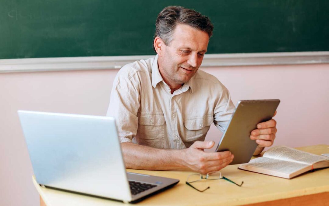 a teacher working on a tablet planning an ai curriculum