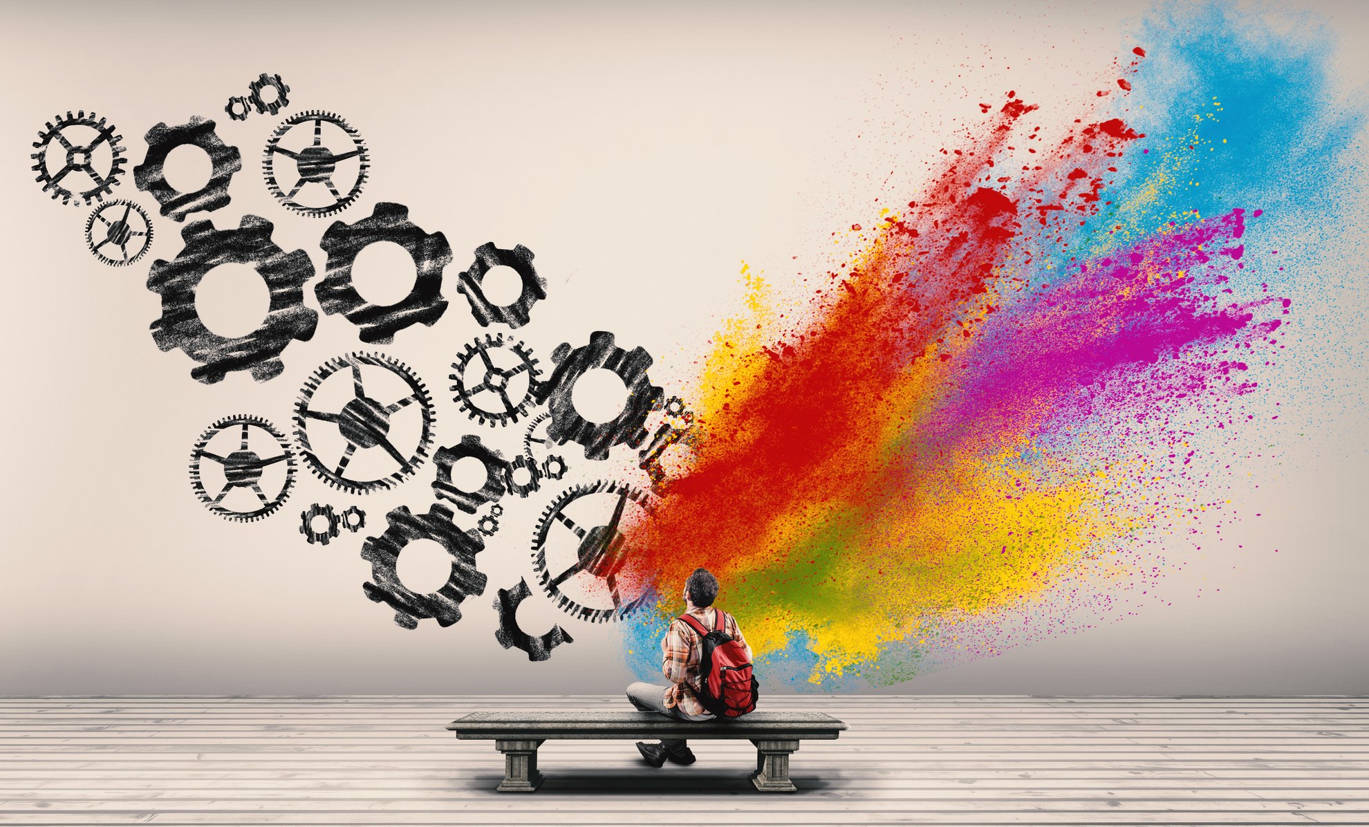 Student on bench looking at wall with gears and color spraying denoting social thinking