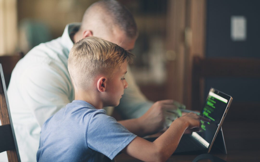 young boy learning to code on a tablet using algorithms