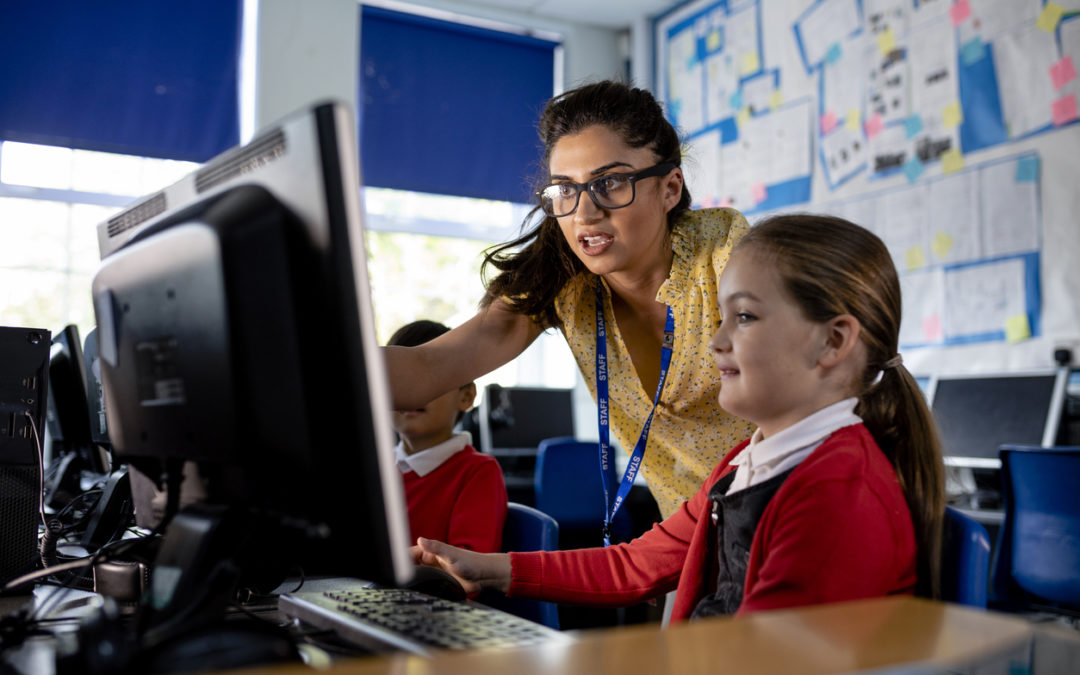 Student learning essential computer skills on computer at school