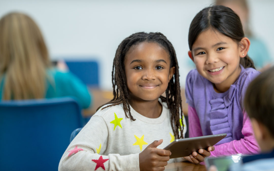 Young students practicing digital literacy on tablet