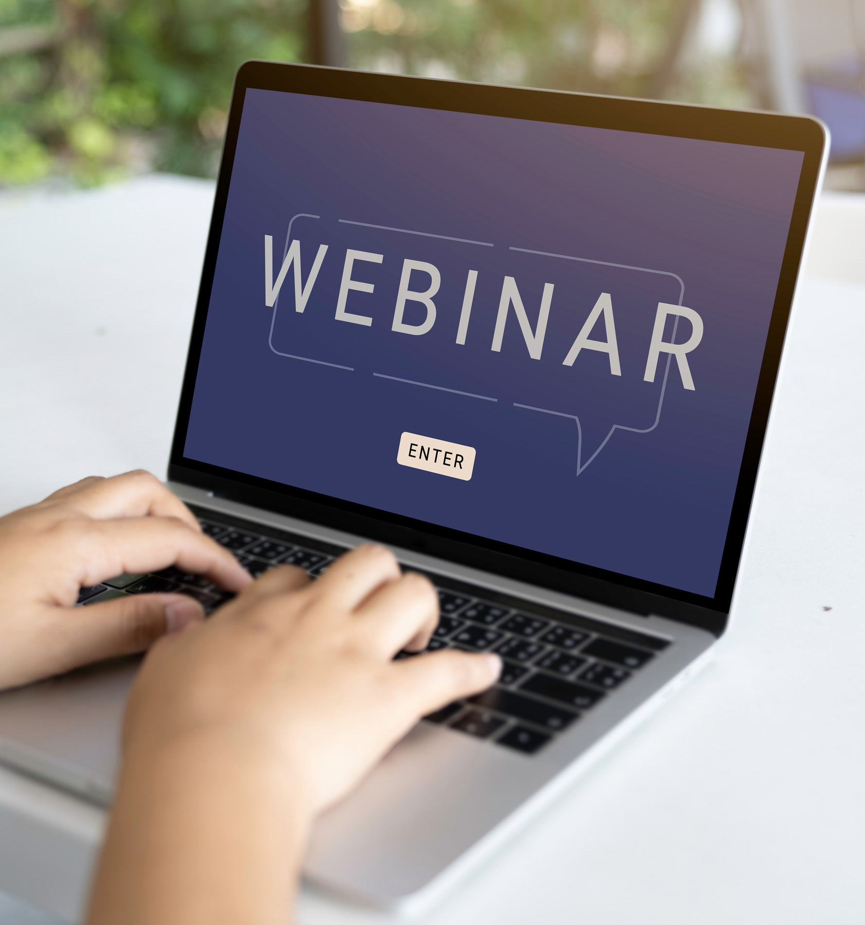 Early middle school male student standing, holding laptop in hand, and using AI to learn