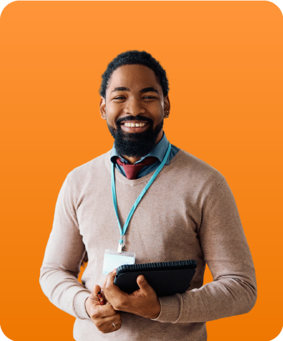 Male administrator holding tablet, looking at camera and smiling.