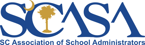 Group of learners around computer smiling